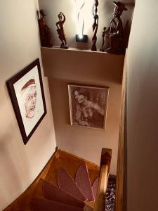 a stairway with pictures on the wall and a picture of a woman at LE HAVANA-Maison d'hotes in Bergerac