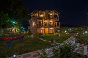 a house at night with a bench in the yard at Villa Doxa in Sarti