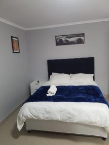 A bed or beds in a room at Home On Hussar Guesthouse
