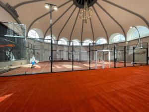 a gym with a tennis court in a building at The Bay Hotel in Cape Town