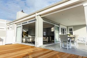 an open patio door with a table and chairs on a deck at Kingswood Hamlet No 5 in George