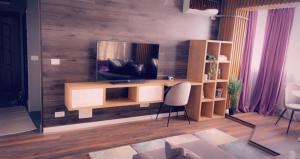 a living room with a television on a wooden wall at Lovely 2 Rooms apartment in the CENTER of the city in Bucharest