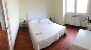 1 dormitorio con 1 cama con colcha blanca en Casa Centrale- Holiday House, en Matera