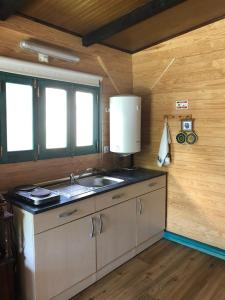 A kitchen or kitchenette at CABANA DO SOL