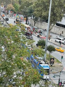 a bus driving down a busy city street with cars at Miller Hotel & Travel Agency in Istanbul