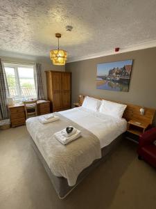 a bedroom with a large bed with a tray on it at Yaxham Mill in East Dereham