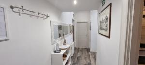 a hallway with white walls and wooden flooring at R.&T. Suite House Roma in Rome