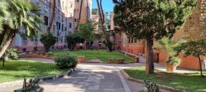 a street in a city with palm trees and buildings at R.&T. Suite House Roma in Rome
