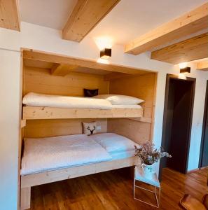 two bunk beds in a room with wooden floors at RotmeerHaus in Feldberg