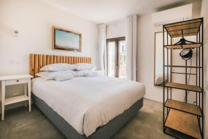 a bedroom with a large bed and a book shelf at MUTE Hostel Porto Covo in Porto Covo