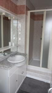 a white bathroom with a sink and a shower at Hotellerie Normande in Dozulé +55 photos