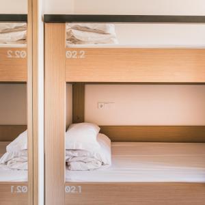a closet with two bunk beds in it at MUTE Hostel Porto Covo in Porto Covo