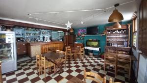 a restaurant with a table and chairs and a bar at Hotellerie Normande in Dozulé