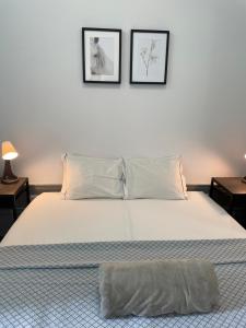 a bedroom with a white bed and white walls at By Doors Hostel in Porto