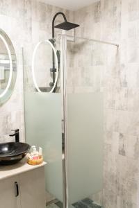 a shower with a glass door in a bathroom at Apartament ALESSIA in Drobeta-Turnu Severin +20 photos