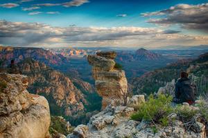 a person standing on the edge of a mountain overlooking a canyon at Sedona Room Homestay - Thunder Mountain in Sedona