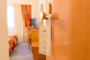 a sign on the door of a hotel room at Hotel Astor in Mar del Plata