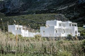 un grupo de edificios blancos en una colina en Muses, en Egíali