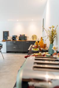 a kitchen with a table with plates of food on it at VILLA MAGNOLIA in Montpellier