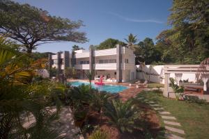a house with a swimming pool in front of it at CASA-22 Luxury Boutique Hotel in Sosúa