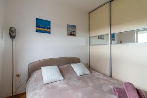 a bedroom with a bed with a large glass closet at Apartment Ben1 in Pula