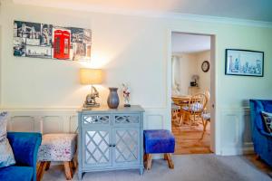 a living room with a blue table and a blue couch at The Old Stables in Tetbury