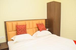 Postel nebo postele na pokoji v ubytování KIFA RESIDENCY
