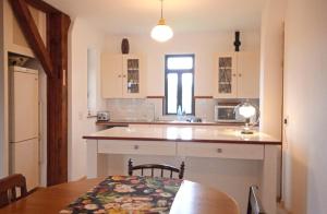 a kitchen with a table and a counter top at Fleur Bleue & The Timber Frame in Heidelberg