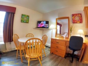 a dining room with a table and chairs and a mirror at Sherwood Inn and Motel Charlottetown in Charlottetown