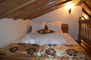a dog laying on a bed in a bedroom at Medieval Apartment in Sighişoara