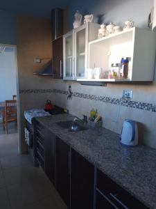a kitchen with a sink and a counter top at Rufina Alojamiento in Playa Unión
