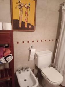 a bathroom with a toilet and a sink at Rufina Alojamiento in Playa Unión