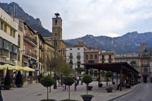a city street with buildings and a clock tower at Hotel Tharsis in Cazorla