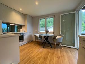 a kitchen and dining room with a table and chairs at Appartement Schillerkopf in Bludenz