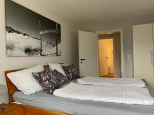 a bed with pillows on it in a bedroom at Appartement Schillerkopf in Bludenz