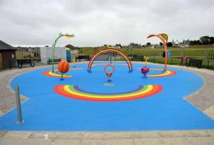 a playground with a blue floor and several different rides at Four Winds Holiday Let in Nairn