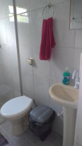 a small bathroom with a toilet and a sink at Villa Flor e Cor in Cavalcante +35 photos