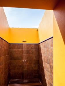 a bathroom with a shower with a yellow ceiling at Monte da Esperanca in Esperança +29 photos