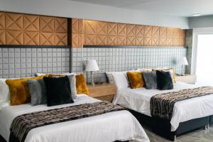 Cama o camas de una habitación en KH HOTEL BOUTIQUE