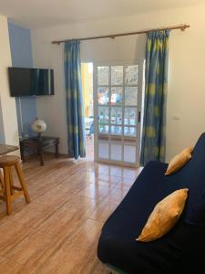 a living room with a couch and a sliding glass door at Apartamento en La Gomera, Playa de Santiago, Alajeró in Playa de Santiago