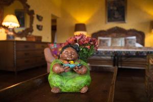 a little girl sitting in a living room holding a stuffed animal at Hotel Atitlan in Panajachel
