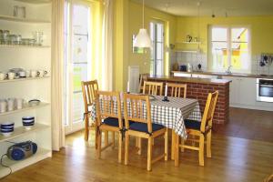 a dining room with a table and chairs in a kitchen at Holiday village Mamry directly on the lake in Trygort in Trygort