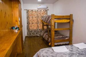 a room with two bunk beds and a wooden counter at LA MARTINA APART HOTEL in San Ignacio +16 photos