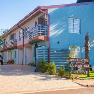 a blue building with a sign in front of it at LA MARTINA APART HOTEL in San Ignacio