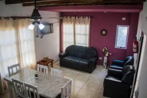 a living room with a table and a couch and a chair at LA MARTINA APART HOTEL in San Ignacio