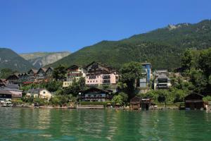 a village on the shore of a lake with houses at Pension Linortner in St. Wolfgang