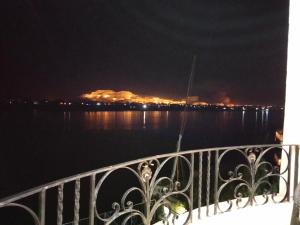 a view of the water at night from a balcony at Nile queen Apartments for Rent in Luxor