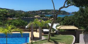 a view of the water from a house with a swimming pool at Chez monsieur in Búzios
