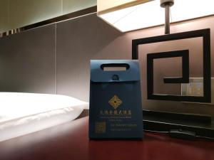 Postel nebo postele na pokoji v ubytování Tianhong Jinling Grand Hotel