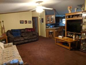 a living room with a couch and a flat screen tv at Thomas Holiday Home in Clearfield